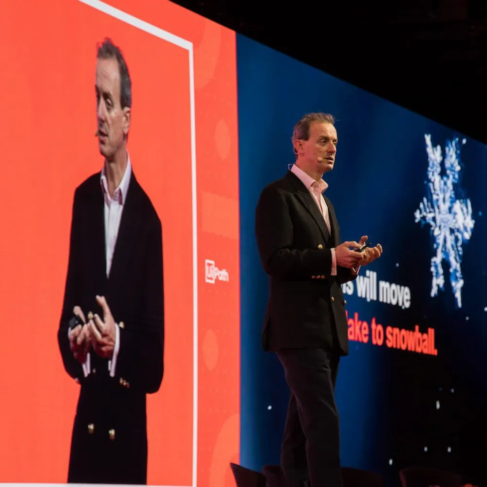 Guy Kirkwood presenting on stage